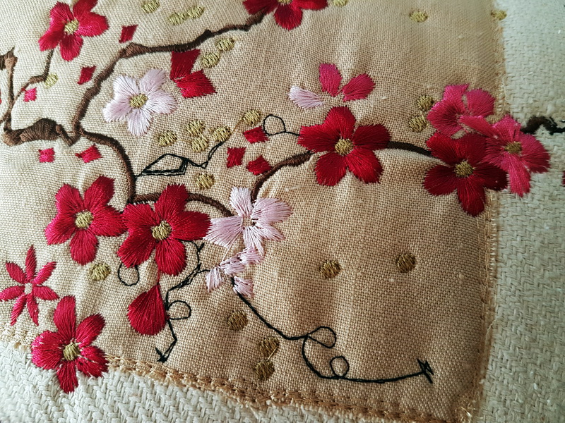 In the Air Machine Embroidery Designs. Close up of embroiderd floral cushion.